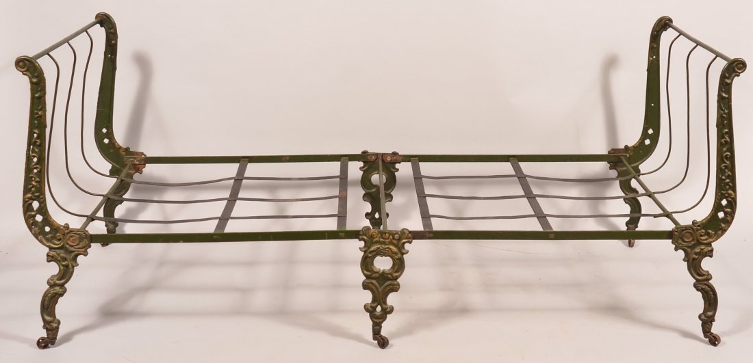 Late 19th century Ornate Cast Iron Day Bed. Green paint: Late 19th century Ornate Cast Iron Day Bed. Green paint with yellow trim. 31-1/2"h. x 29-1/2"w. x 74"l. Condition: good with wear and minor rust.