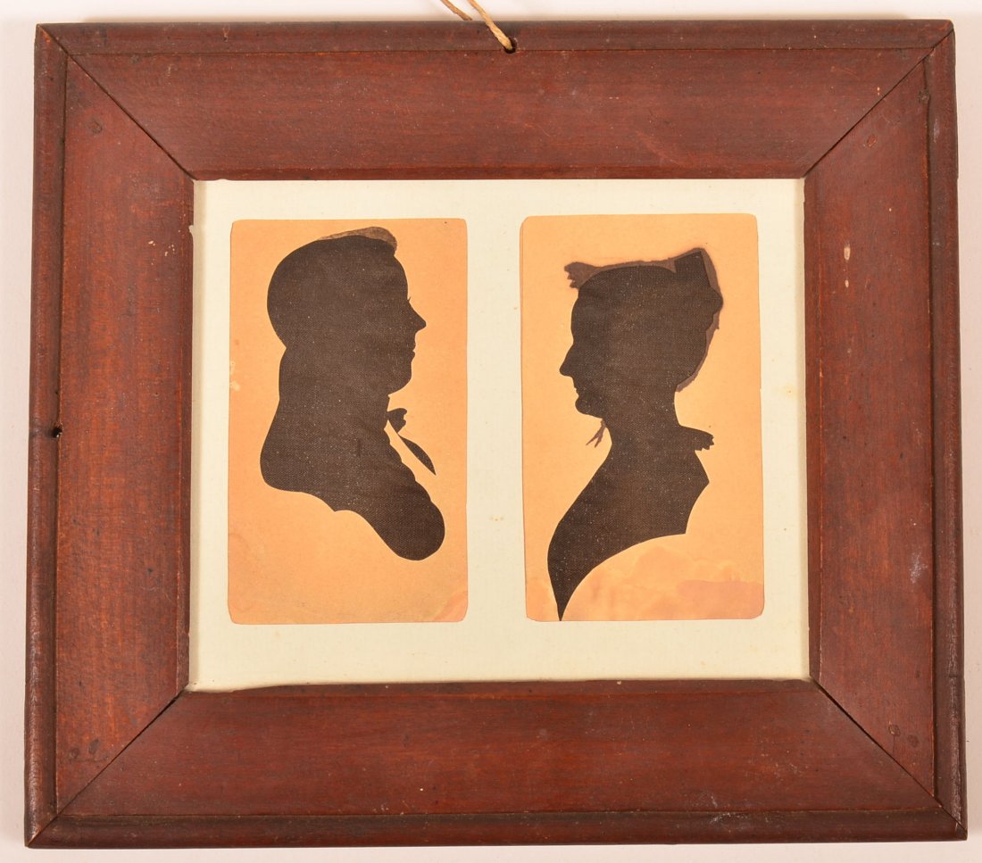 American 19th Century Double Hollow Cut Silhouettes of: American 19th Century Double Hollow Cut Silhouettes of a Gentleman and Woman. Unsigned and unidentified. In a good period red painted frame, 7-1/4" x 8-1/8" overall. Condition: Good with minor stains.