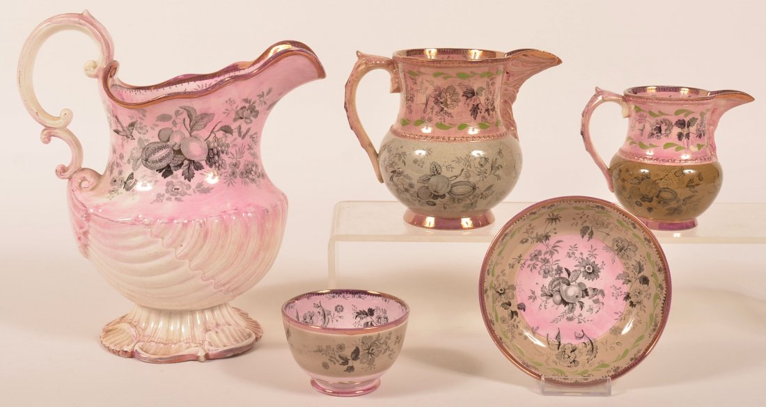 Four Pieces of Staffordshire Pink Lustre "Fruit No. 11": Four Pieces of Staffordshire Pink Lustre "Fruit No. 11" Pattern China. Nautalis shell water pitcher, 10-3/4"h., two various cream pitchers and a Handleless cup and saucer. Condition: Good with some mi