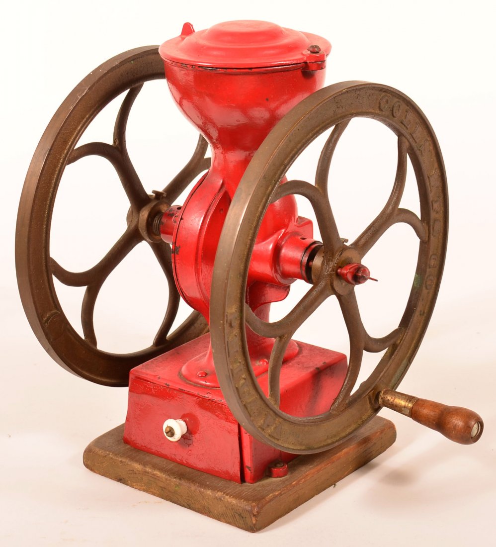Coles Cast Iron Coffee Mill. Signed Coles Mfg. Co.: Coles Cast Iron Coffee Mill. Signed Coles Mfg. Co. Philadelphia, table top model having double 9-1/2"dia. Wheels and grip handle, tin lower drawer on wood base. 12-1/2"h. Condition: Very good.