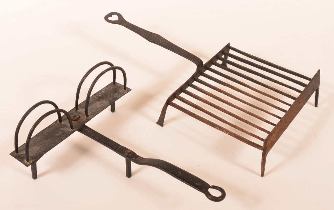 Two Wrought Iron Hearth Tools. Grid iron with shaped: Two Wrought Iron Hearth Tools. Grid iron with shaped handle with heart cut-out, Toaster with arch supports, 20-1/4'l. and 15"l. Condition: Good.