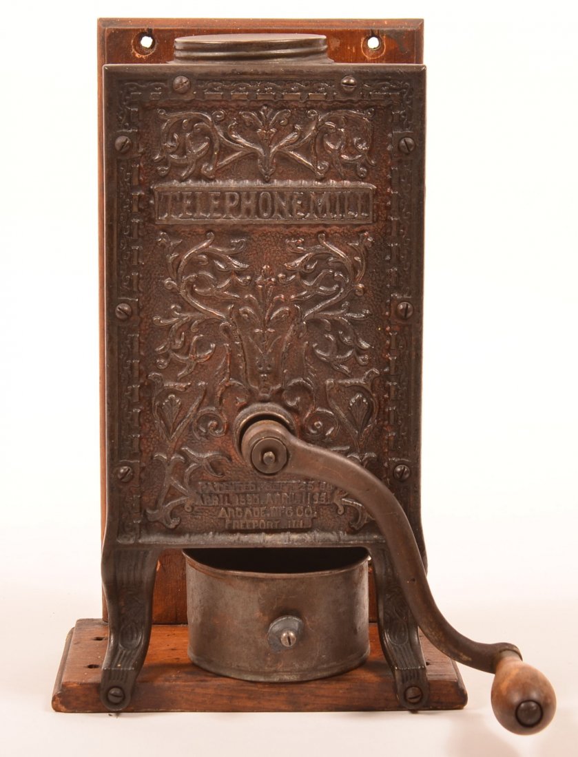 Arcade Mfg. Co. Cast Iron "Telephone" Coffee Mill. Cast: Arcade Mfg. Co. Cast Iron "Telephone" Coffee Mill. Cast iron front, wood case and base and tin cup. 13-1/4"h. Condition: Very good.