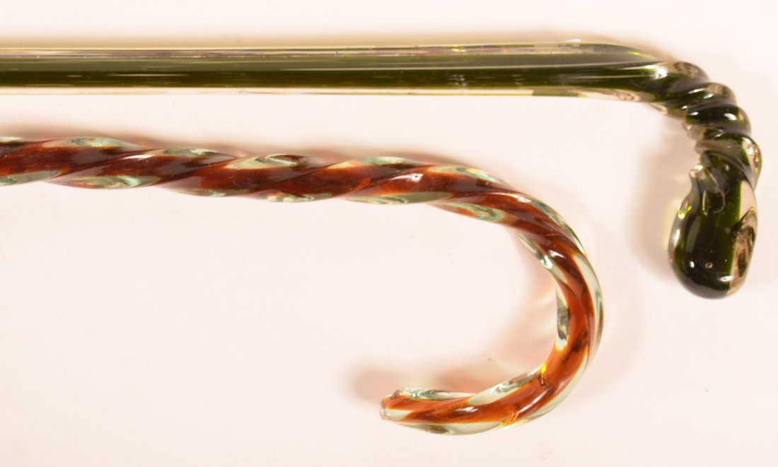 Two Antique Colored Glass Canes with spiral shafts.