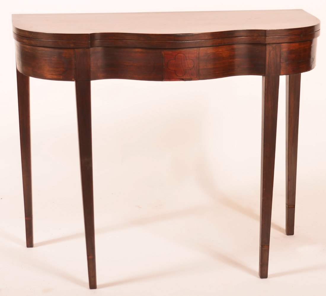 American Hepplewhite Inlaid Mahogany Serpentine Front: American Hepplewhite Inlaid Mahogany Serpentine Front Gate-leg Game Table. Skirt with central clover inlay flanked by oval inlays and tapered legs. 29-3-4"h. x 36-1/2"w. x 17-1/2"d. Condition: Good wi