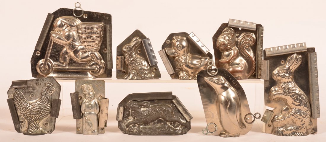 Nine Vintage Animal Figural Chocolate Molds. Including: Nine Vintage Animal Figural Chocolate Molds. Including rabbit on scooter, rabbits, snowman, Penguin, squirrel, duck and hen, snowman marked made in Germany Van Emden Co, New York, hen and running rabb