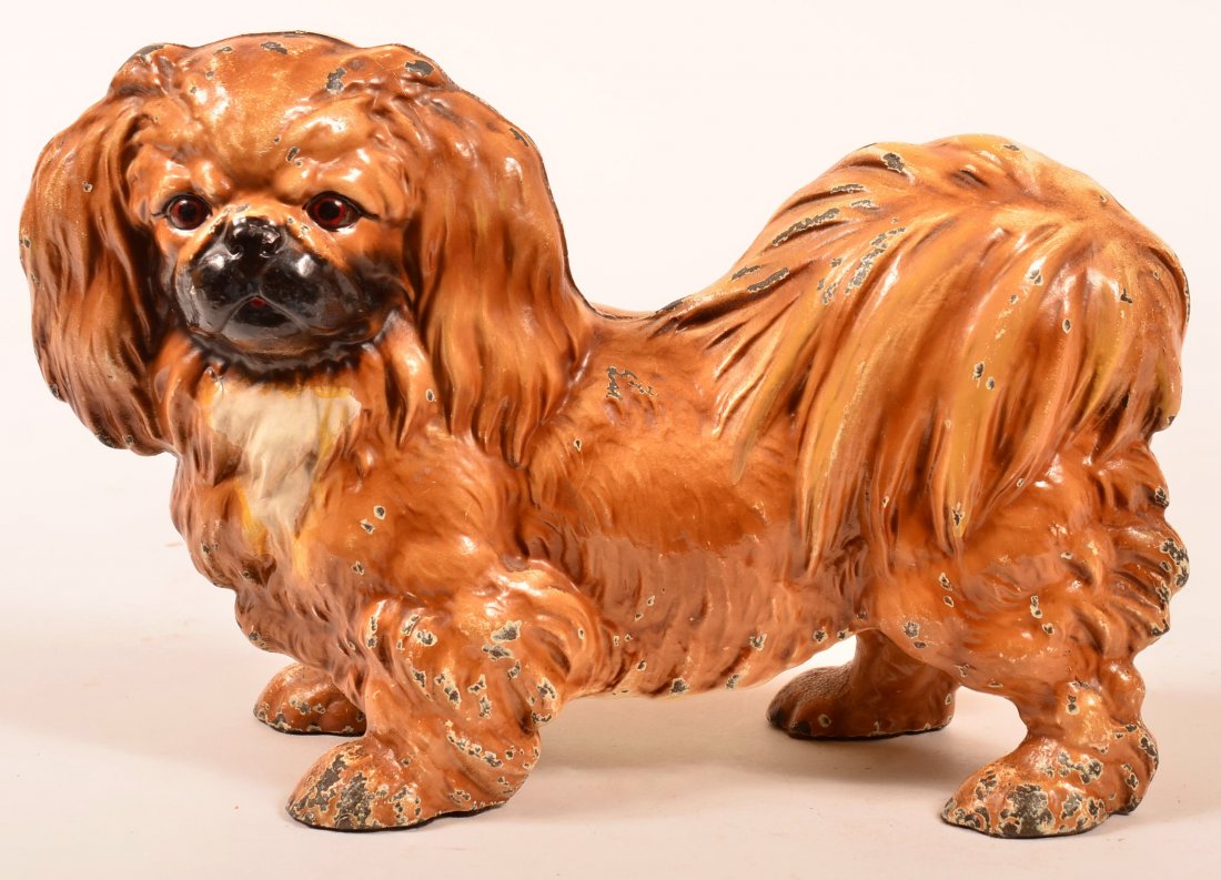 Hubley Cast Iron Pekingese Dog Doorstop. Life-size: Hubley Cast Iron Pekingese Dog Doorstop. Life-size portrayal painted in natural colors. 14" long. Condition: Very good with minor wear.