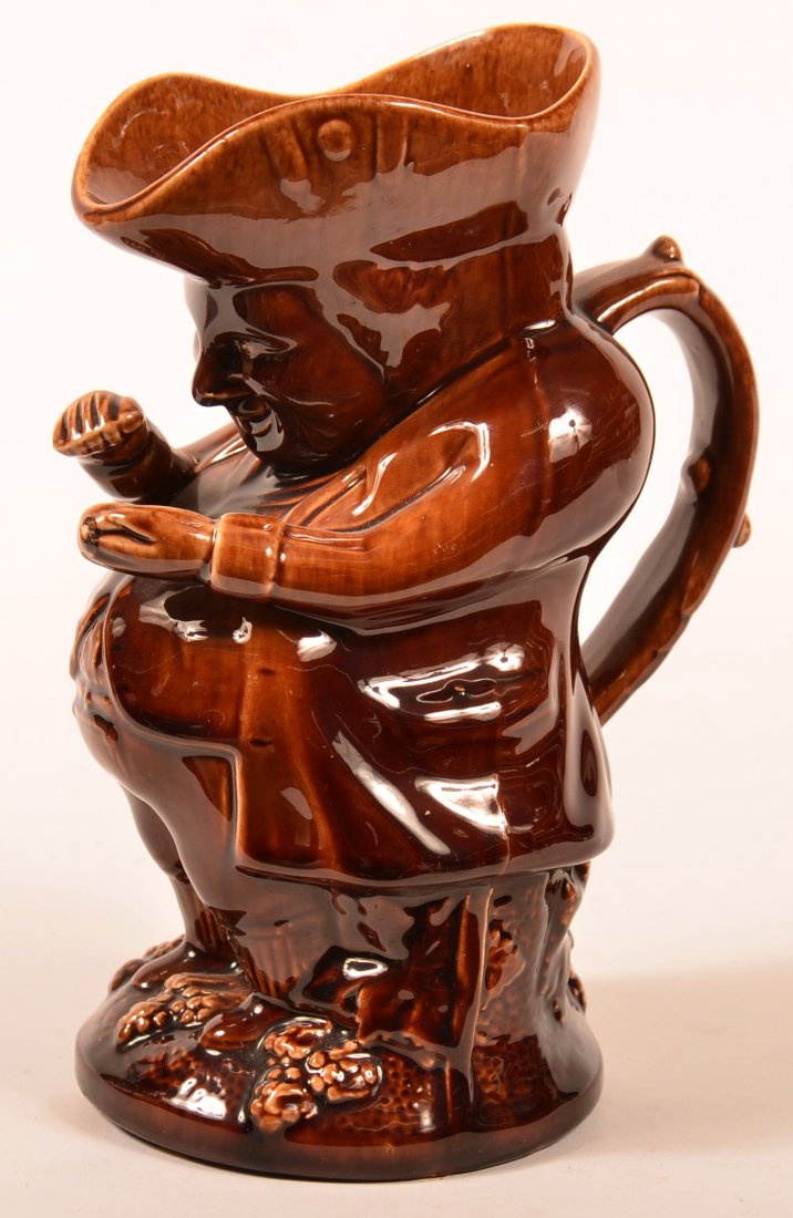 19th Century Rockingham Glazed Yellowware Figural Toby: 19th Century Rockingham Glazed Yellowware Figural Toby Jug. 9-1/2"h. Condition: Very good, one small chip under base.