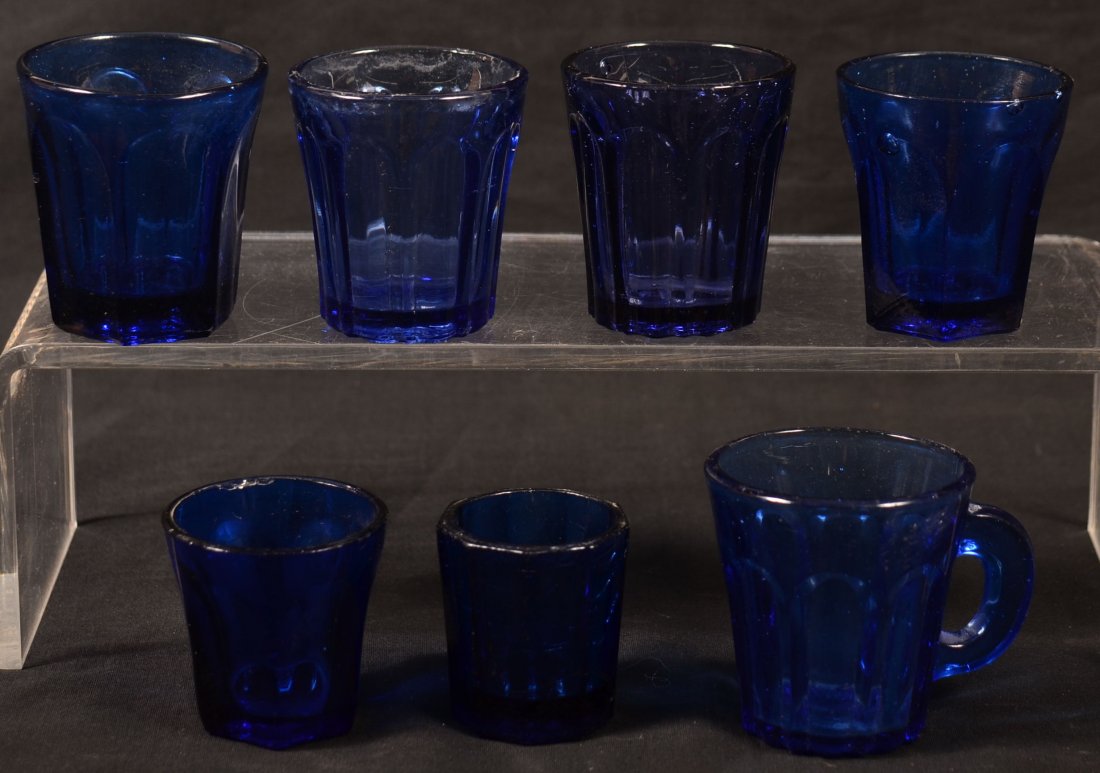 Lot of Seven Cobalt Blue Blown Flint Glass Paneled Shot: Lot of Seven Cobalt Blue Blown Flint Glass Paneled Shot Glasses and a Miniature Mug. 1-3/4" to 2-3/8"h. Condition: good with minor chips.