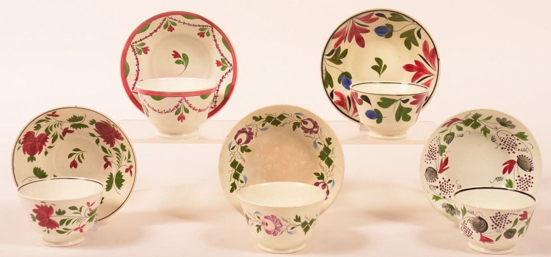 Five Various Staffordshire Polychrome Floral and: Five Various Staffordshire Polychrome Floral and Foliate Decorated Handleless Cups and Saucers. Saucers measure 5-3/4" to 6" diam. Condition: One cup with hairline, One saucer with edge chip.