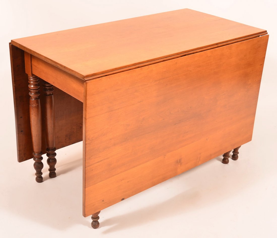 Sheraton Cherry Eight Leg Gate Leg Drop-leaf Table with: Sheraton Cherry Eight Leg Gate Leg Drop-leaf Table with Boldly Turned Legs. 28"h. x 44"w. x 23" d.; Each leaf measures 24". Condition: Refinished, wear and scratches.