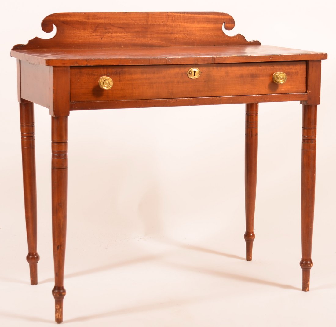 Sheraton Mixed Wood Dressing Table with Scrolled Back: Sheraton Mixed Wood Dressing Table with Scrolled Back Slash. Full width dovetailed skirt drawer and turned legs. 31-1/4"h. x 31-1/2"w. x 15-3/4"d. Condition: Old refinish, normal wear and losses.