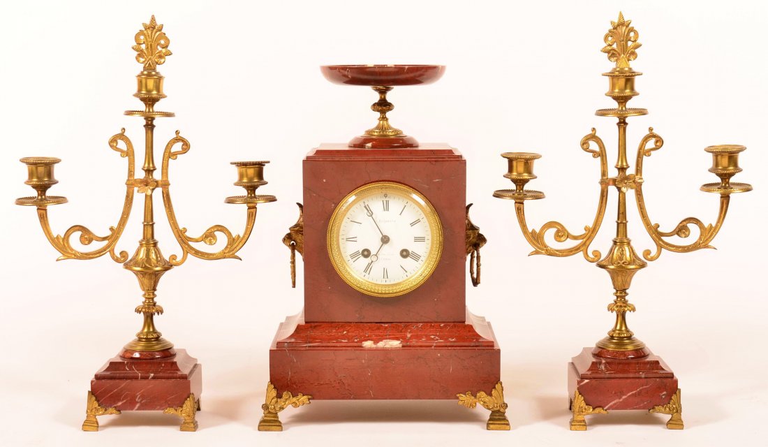 French Marble Three Piece Garniture Set. Clock enamel: French Marble Three Piece Garniture Set. Clock enamel dial signed L. Barbaste, Paris and a Pair of matching brass triple socket candelabras. Clock measures 13-3/4"h.; Candelabras 15 3/4"h. overall. Co