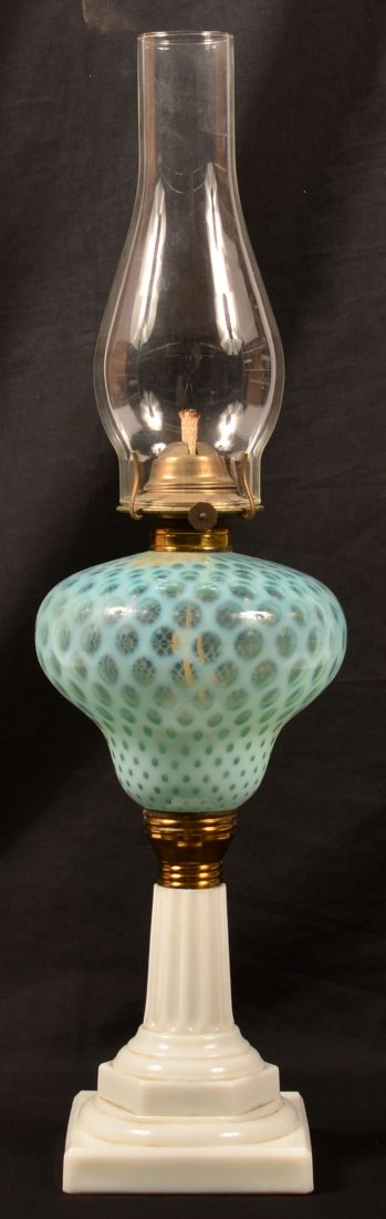 Blue Opal Escent Glass Coin Dot Font Fluid Lamp. Opaque: Blue Opal Escent Glass Coin Dot Font Fluid Lamp. Opaque white glass pedestal base and hurricane shade. 13-1/2" high to top of collar, 23-3/4" high overall. Condition: Good with minor chips.
