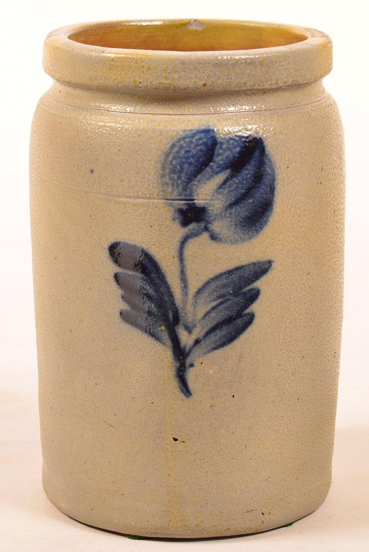 Unsigned Blue Slip Decorated Stoneware Two Quart: Unsigned Blue Slip Decorated Stoneware Two Quart Canning Jar. Molded lip. Triple tulip and foliate cobalt blue decoration. 8-1/2"h. Condition: Very good, one interior chip.