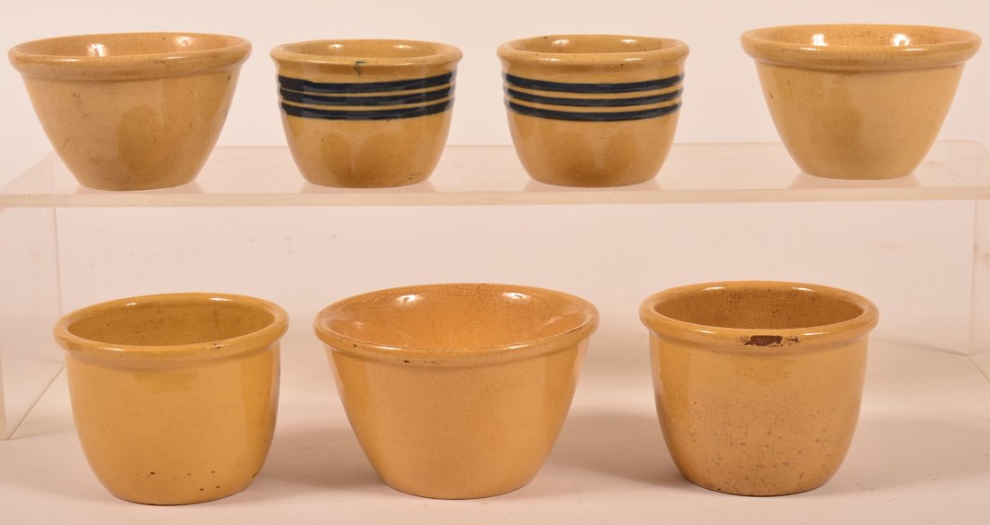 7 Yelloware Custard Cups Two w Blue Slip lines Sizes 3": 7 Yelloware Custard Cups Two w Blue Slip lines Sizes 3" to 4" Diam. Condition: Crazing and a few tight lines