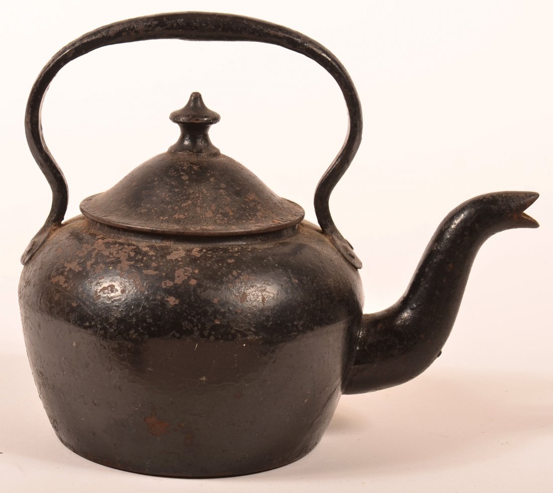 19th Century Cast Iron Tea Kettle Signed Carron.: Small 19th Century Cast Iron Tea Kettle Signed Carron. Fixed bale handle, turned finial on dome lid, goose neck spout and bulbous body. 7-1/2"h. Condition: Good, rust and pitting.