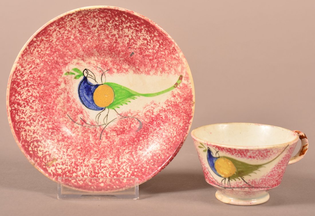 Red Spatter Peafowl Child's Cup and Saucer.: Red Spatter China Peafowl Pattern Child's Cup and Saucer. Blue, Yellow and green Peafowl decoration, saucer measures 4-5/8" diam. Condition: Saucer is good, cup has crude glue repair on handle and two