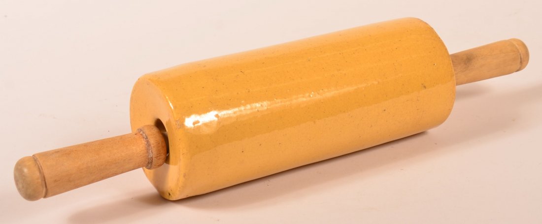 Glazed Yellowware Pottery Rolling Pin.: Glazed Yellowware Pottery Rolling Pin with Turned Wooden Handles. 15" l. overall. Condition: Good, one small edge chip.