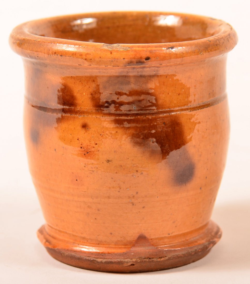 Mottle Glazed Redware Miniature Crock.: Mottle Glazed Redware Miniature Crock. Molded rim, incised band, ovoid body. 2-3/4"h. Condition: Good, minor chips.
