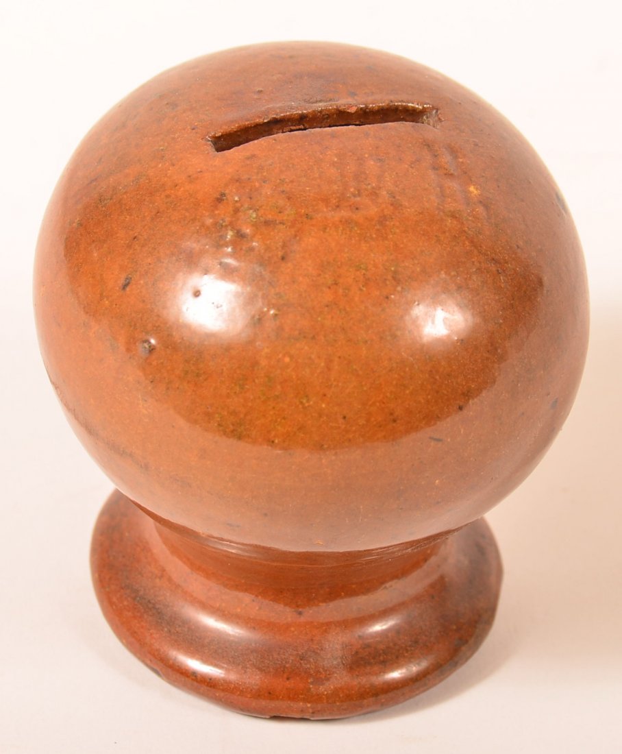 Glazed Redware Pottery Sphere Form Still Bank.: Glazed Redware Pottery Sphere Form Still Bank. Illegible incised initials above coin slot. 3-1/2"h. Condition: Very good, couple of glazing pops.