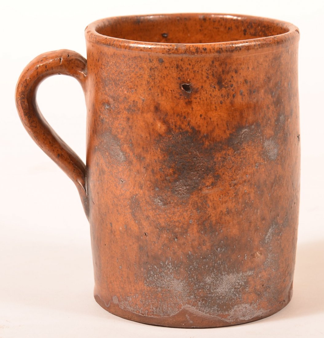 Mottle Glazed Redware Mug.: Mottle Glazed Redware Pottery Straight Sided Mug with Applied Loop Handle. 5"h. Condition: Very good, professional repair on upper rim.