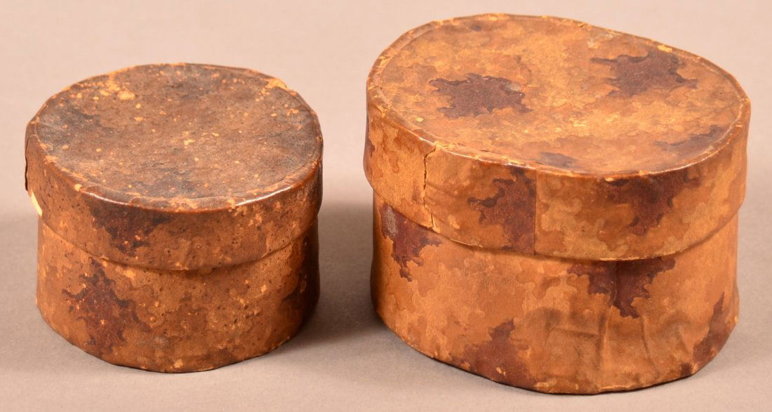 Two 19th Century Wallpaper Boxes.: Two 19th Century Wallpaper Boxes. Dark brown and yellow decoration on tan ground, both newspaper lined. One oval 1-5/8"h. x 2" w. x 2-1/2"l. One round 1-1/4"h. x 2" diam. Condition: Fair, stains, fadi