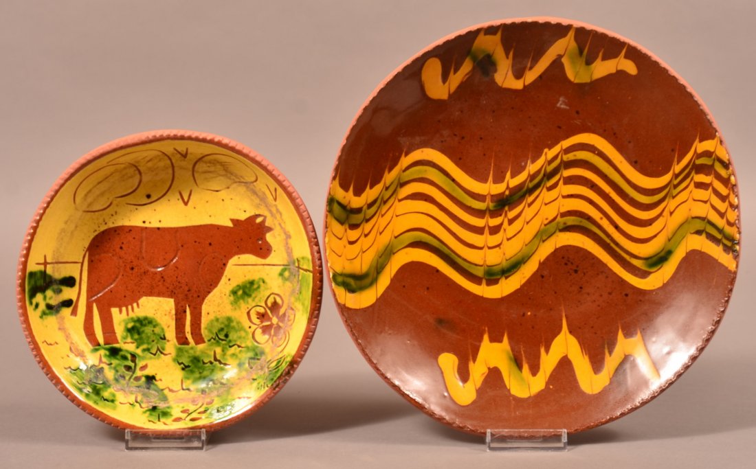 Two Breininger Redware Pottery Plates.: Two Breininger Redware Pottery Plates. One with cow decoration, 7-3/4" diam. One with slip decoration, 10-1/2" diam. Condition: Good.