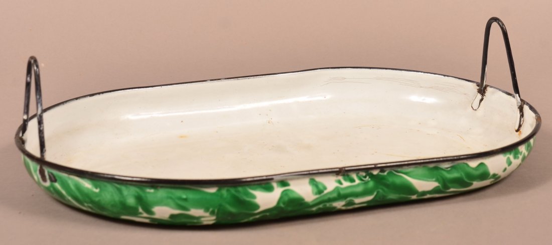 Emerald Green Granite Ware Baking Pan.: Emerald Green Granite Ware Oblong Baking Pan. Large swirl, black trim and wire handles. 4"h. x 16-1/4"w, 10-1/4"d. Condition: Good, minor wear and losses.
