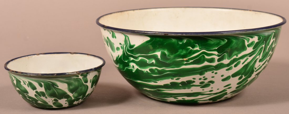 Two Emerald Green Granite Ware Mixing Bowls.: Two Emerald Green Granite Ware Mixing Bowls. Large swirl, blue trim. 2-1/4"h. x 5" diam. And 4-1/8"h. x 10" diam. Condition: Good with minor wear.