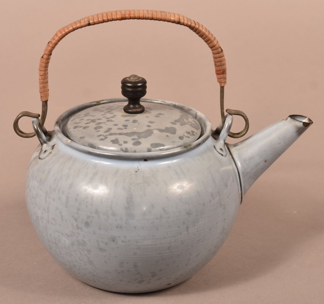 Gray Granite Ware Teapot: Gray Granite Ware Teapot . Medium mottled, squat form, bamboo wrapped wire handle, turned wood finial. 7-1/2"h. overall including handle. Condition: Good with minor losses.