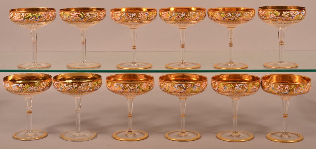 12 French Enamel and gilt Flat Champagnes.: Set of 12 French 19th Century Enamel and Gilt Decorated Flat Champagnes. Polychrome floral, foliate and scroll enamel decoration on gilt bands, fine quality. 5"h. Condition: Very good with some losses