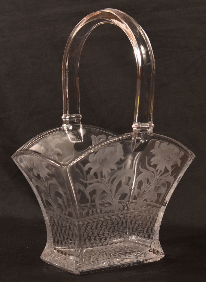 Heisey Colorless Glass Basket.: Heisey Colorless Glass Basket with Etched Orchid Pattern. Diamond makers mark. 11-1/2"h. Condition: Very good.