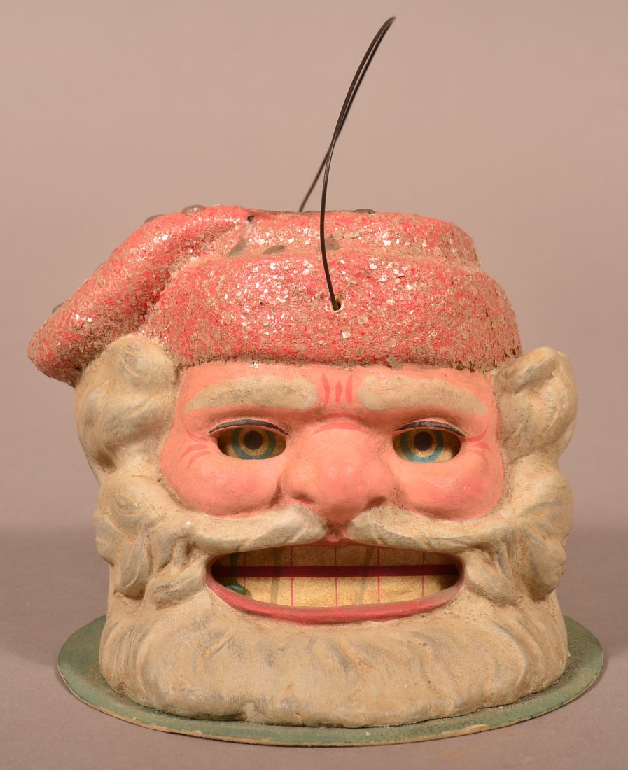 German Santa Head Candle Lantern.: German Paper Mache Santa Head Candle Lantern. Written on base "made in Germany". 5"h. not including wire handle. Condition: Very good, wear, minor losses, candle wax drips.