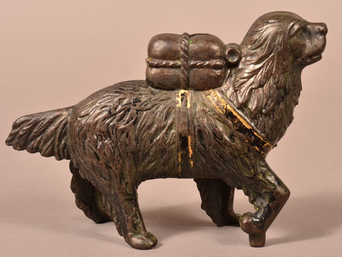 A.C. Williams Cast Iron St. Bernard Dog Bank.: A.C. Williams Cast Iron St. Bernard Dog with Pack Still Bank. Circa 1901-Mid 1930's. 7-3/4"l. Condition: Good with surface and paint wear.