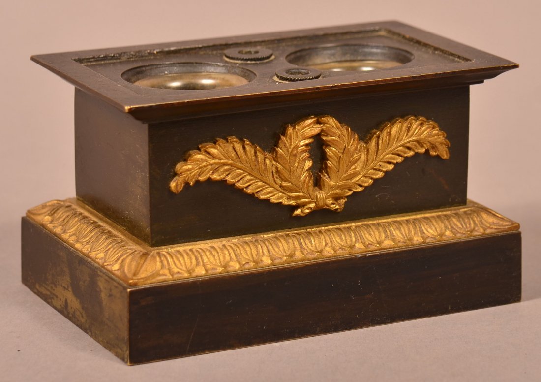 Early Ormolu Mounted Double Inkwell.: Early 19th Century Ormolu Mounted Double Inkwell. Black painted brass with foliate mounting. 2-3/4"h. X 4-3/4"w. X 3"d. Condition: Very good, one glass liner with damage.