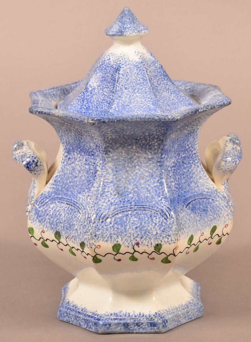 Blue Spatter Holly Berry Covered Sugar Bowl.: Blue Spatter Holly Berry Pattern Ironstone China Covered Sugar Bowl. Paneled form with open loop handles. 7-3/4" h. Condition: Chip on finial of lid, chip repair on one point of upper rim of sugar bow