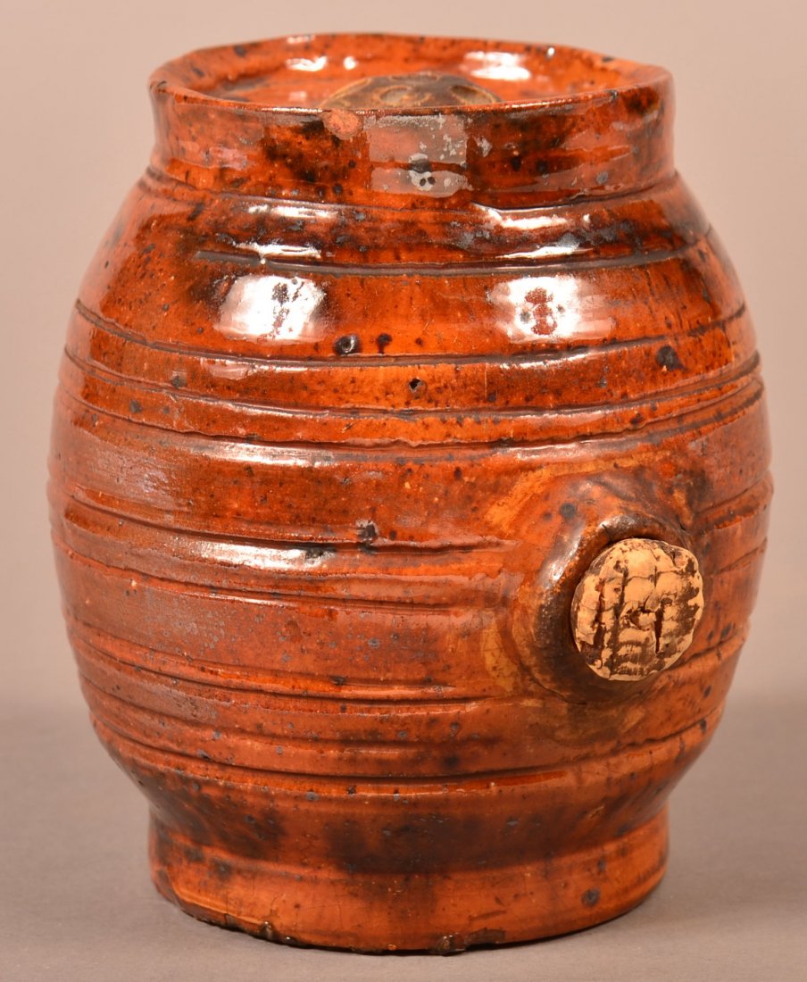 Mottle Glazed Redware Brandy Keg.: 19th Century Mottle Glazed Redware Pottery Brandy Keg. Incised bands on barrel form body and honeycomb top. 5"h. Condition: Good with minor chips and spout repair.