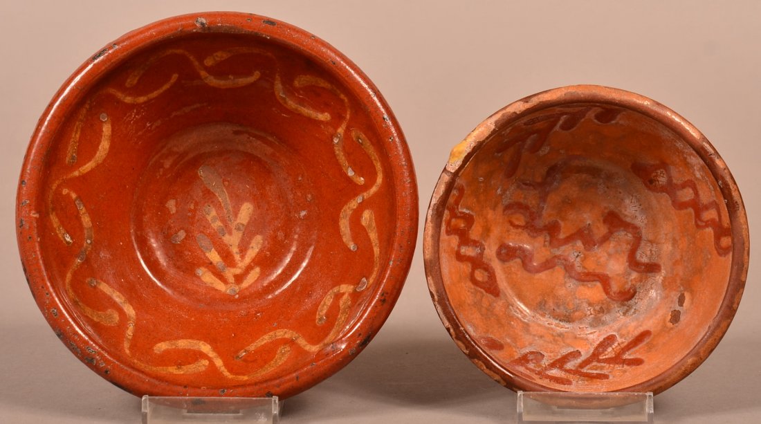Two Slip Decorated Redware Pottery Bowls.: Two 19th Century Slip Decorated Redware Pottery Bowls. With sprig and zig zag slip decoration. 4-7/8" and 5-7/8" diam. Condition: Good with glaze loss.