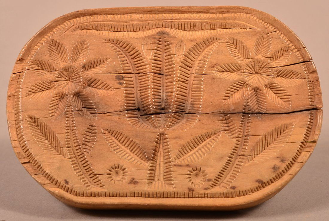 Pennsylvania 1842 Oval Carved Butter Print.: Pennsylvania Oval Carved Butter Print Signed J.H. 1842 . Central tulip flanked by two eight petal flowers, with stepped back and turned suppress ball handle. 4"h. x 6-1/4"w. x 3-3/4" d. Condition: Goo