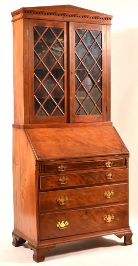 Chippendale Slant Lid Secretary Desk.: Chippendale Mahogany Slant Lid Secretary Desk. Dentil molded cornice, two glazed upper doors with diamond mullions, lower section with prospect door, flanked by drawers and compartments, four full wid