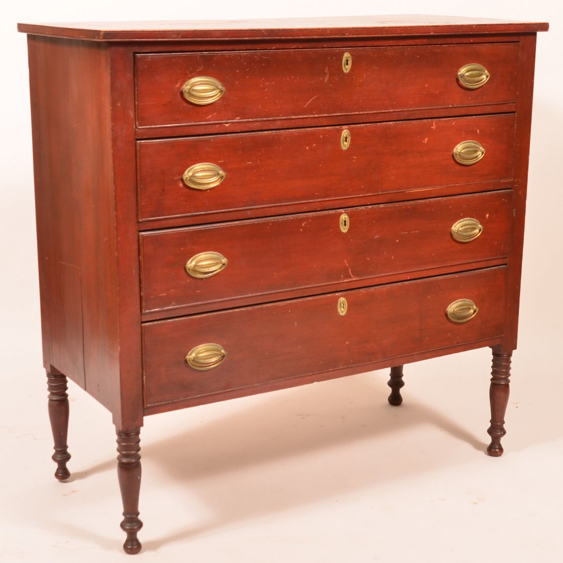 Pennsylvania Sheraton Chest of Drawers.: Pennsylvania Sheraton Cherry Four Drawer Chest of Drawers. Original red surface. Four full width graduated dovetailed drawers with beaded edges and original brass pulls, high turned feet. 40-1/2"h. x 