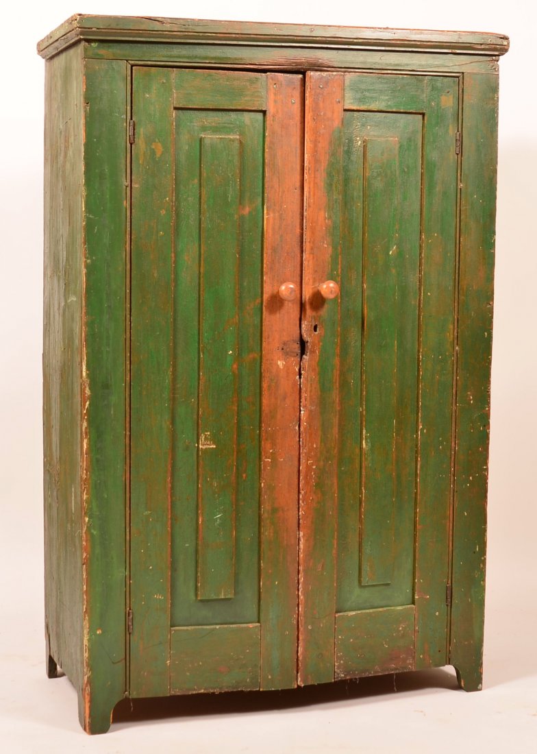 American Softwood Jelly Cupboard.: American Early 19th Century Softwood Jelly Cupboard. Old green painted surface, molded cornice, two raised panel door, interior shelves and cut out feet. 56-1/2"h. x 37"w. x 18-1/2"d. Condition: Fair 