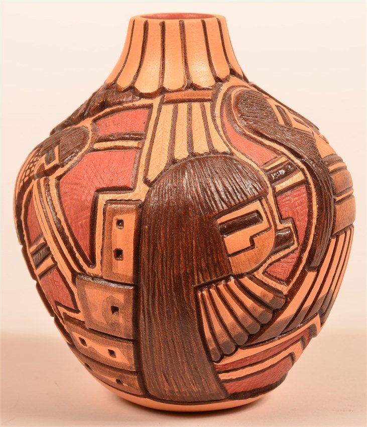 Vase by Tom Polacca (1935-2003), Hopi: Signed and Hallmarked with a cornplant. Tom is the son of Fannie P. Nampeyo and grandson of the legendary Hopi potter, Nampeyo. Polychromed, deeply carved designed of Hopi Priests watching over the Pu