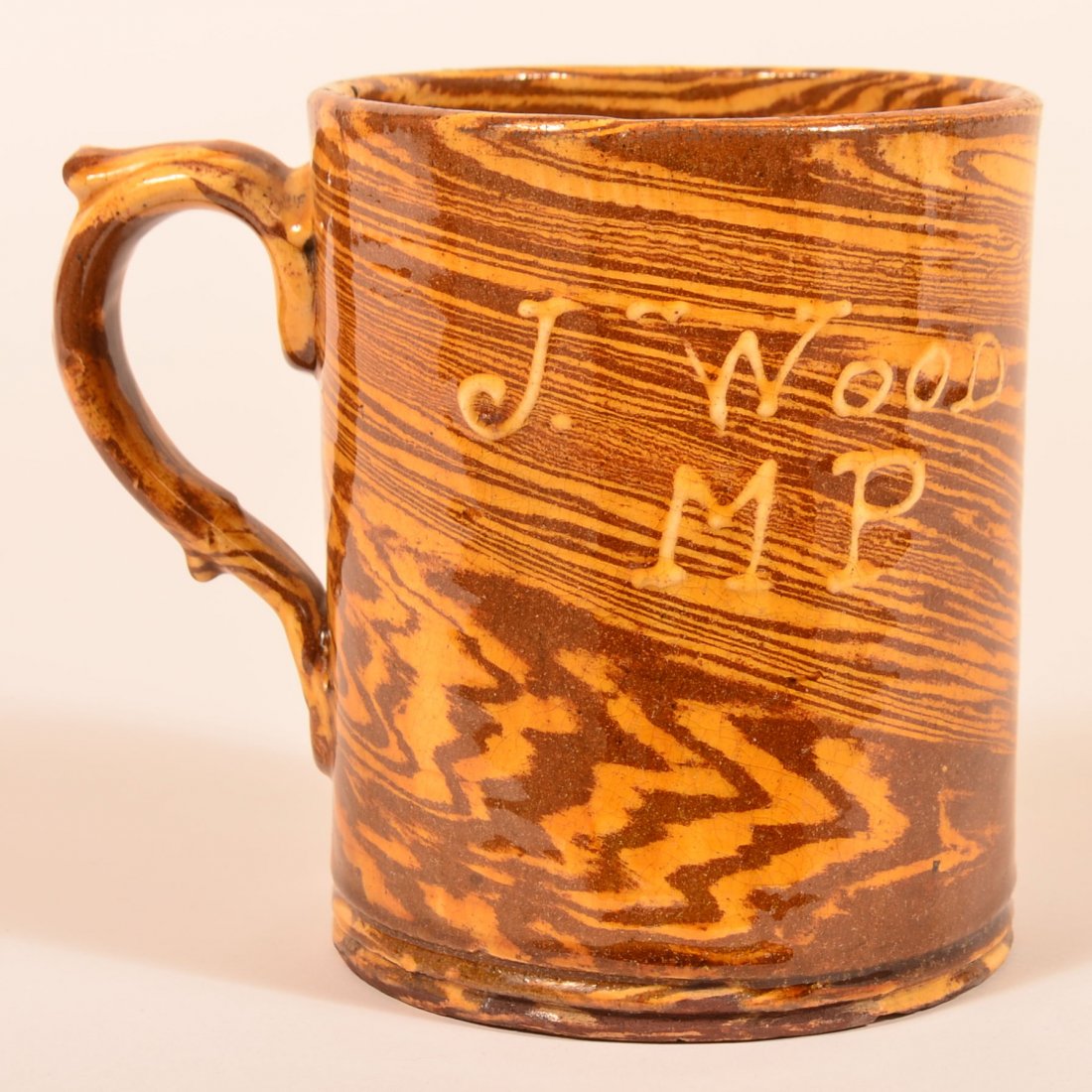 English Scroddleware Redware Large Mug.: English 19th Century Scroddleware Redware Pottery Large Mug. Signed in slip "J. Wood M.P., 1889". 6-1/4"h. Condition: Good with minor glazing wear on rim and hairline.