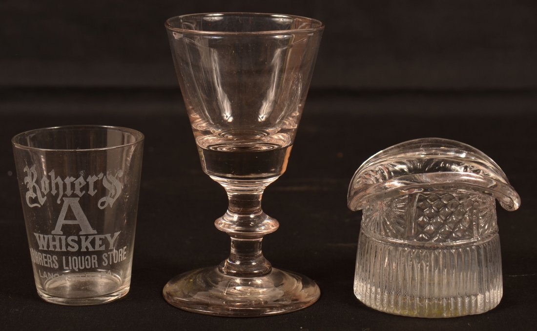 Three Pieces of Colorless Glass.: Three Pieces of Colorless Glass. 1st: Blown three mold hat, 2-1/8"h.; 2nd: Steigel type button knop stem wine, 4"h.; 3rd: "Rohrer's A Whiskey, Lancaster, Pa" shot glass, 2-1/2"h. Condition: Very good.