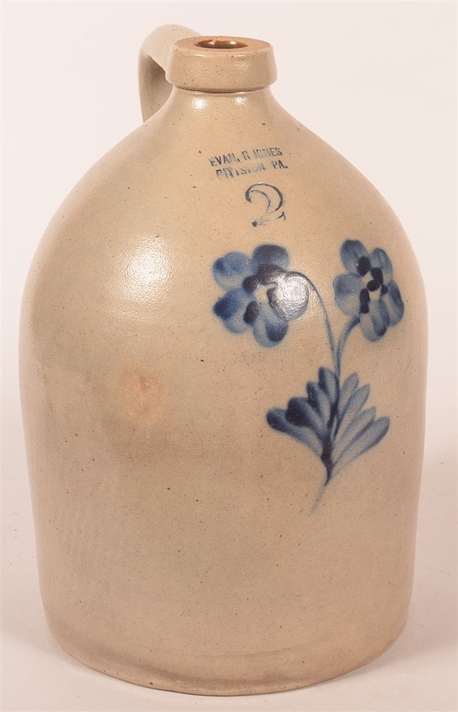 Evan Jones Pittston, PA Slipped Decorated Jug: Evan Jones Pittston, PA 2 Gal. Slipped Decorated Floral Jug. Double daisy and foliate. 13 1/2"h. Condition: Small chip to base.