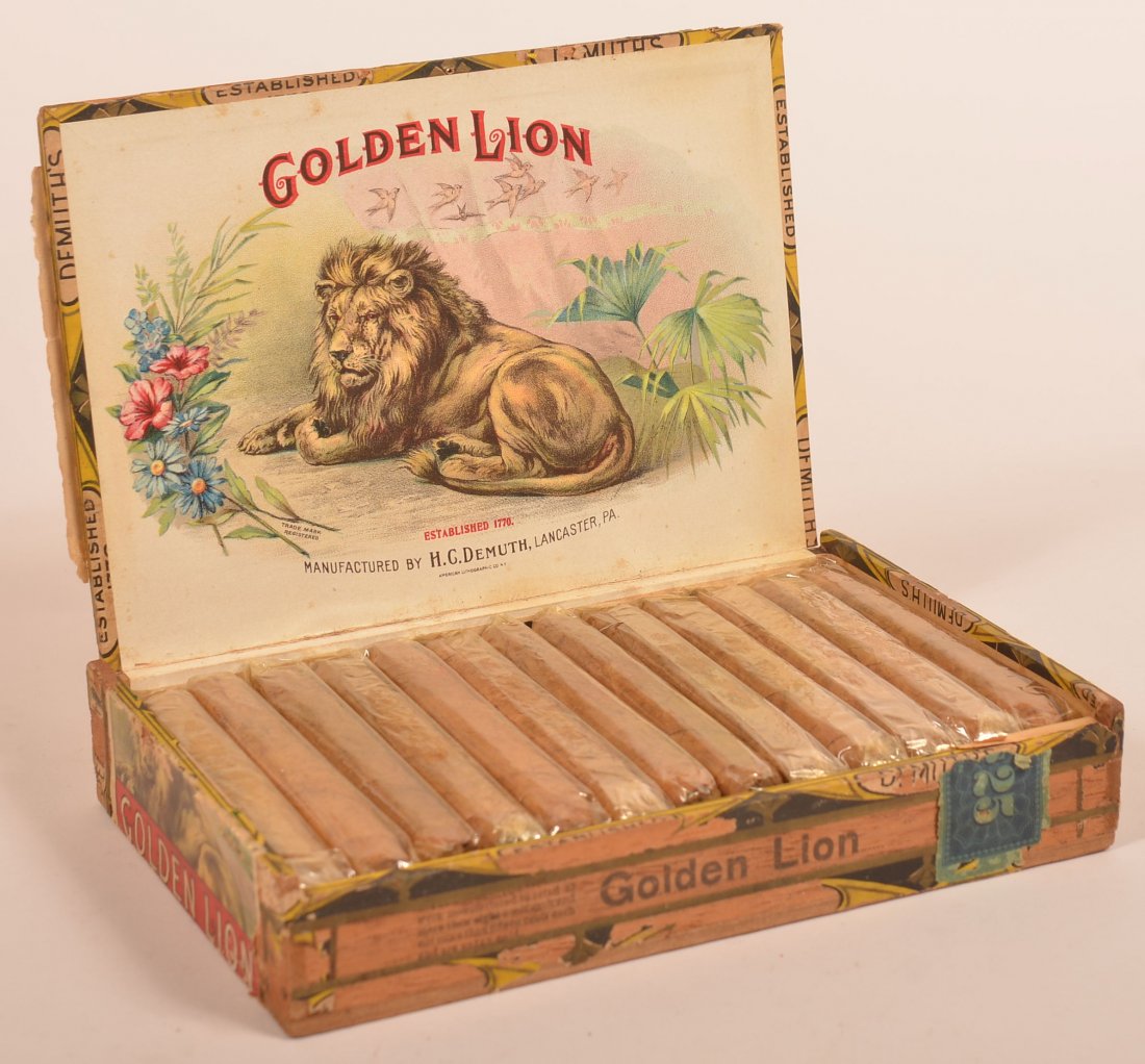 H.C. Demuth, Lancaster Golden Lion Cigar Box.: H.C. Demuth, Lancaster PA Golden Lion Cigar Box. Filled with original cigars. 1-1/2"h. x 8-1/4"w. x 5-1/2"d. Condition: Good with minor wear.