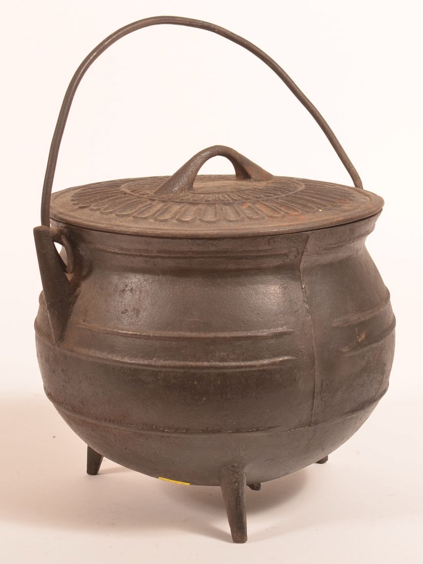 Cast Iron Covered Gypsy Kettle.: Cast Iron Covered Gypsy Kettle. Tripod base with bale handle. 9"h. x 10" diam. Condition: Good with some rust and minor pitting.