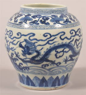 Chinese Porcelain Blue and White Dragon Jar.: Chinese Porcelain Small Blue and White Dragon Jar. Wanli Six-Character Mark in Underglaze Blue within a Double Circle. Circa. 1573-1620. Decorated with two dragons racing above a band of waves and