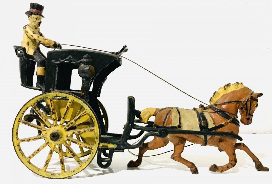 894: PRATT & LETCHWORTH TWO-SEAT SURREY: Cast iron, good detail to paint scheme, yellow and black enclosed cab, seated rear driver, brown horse with white saddle . 12" l.Local shipping cost is $35